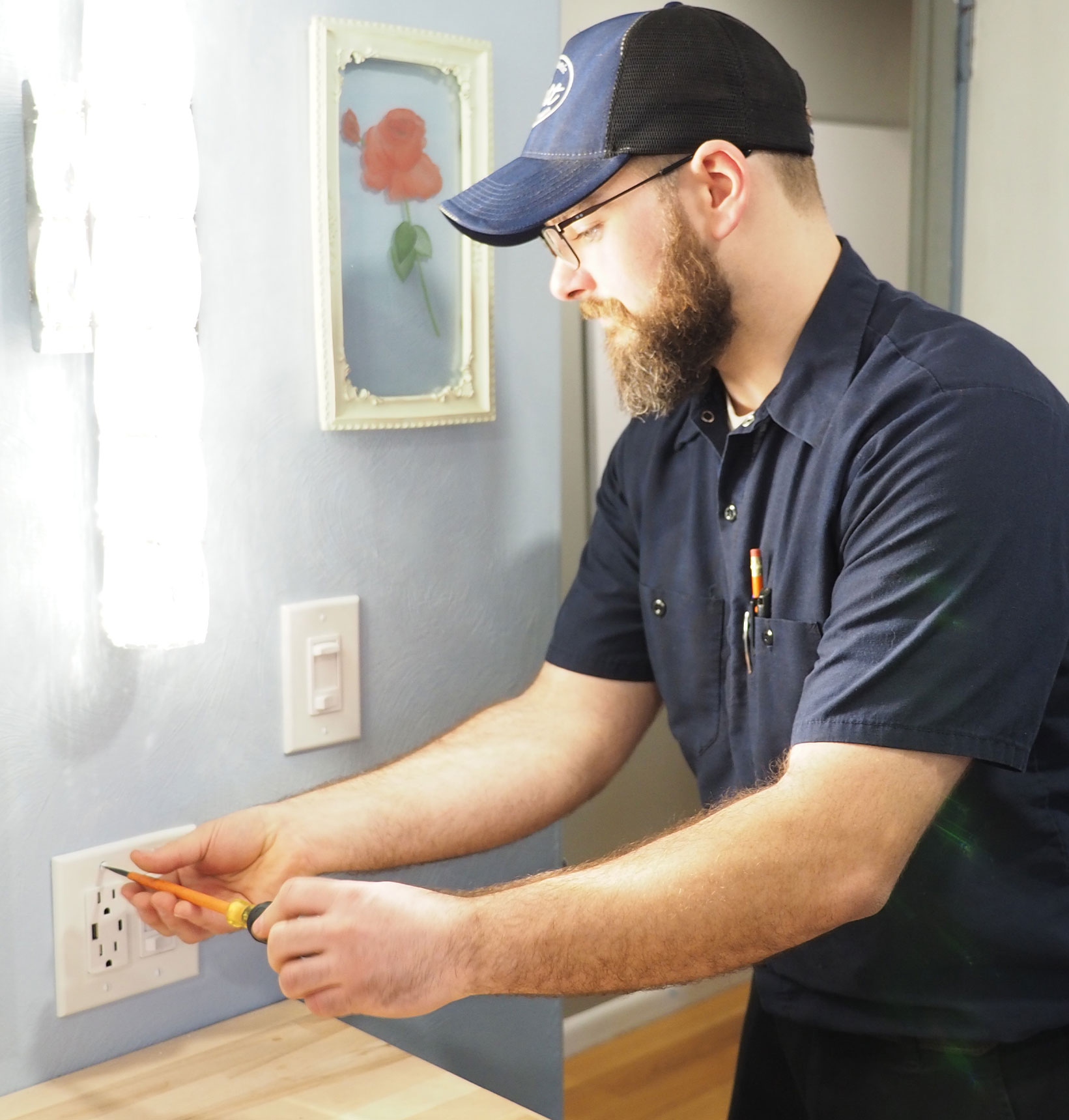 Byers Electric technician installing GFCI outlet in residential bathroom for enhanced safety