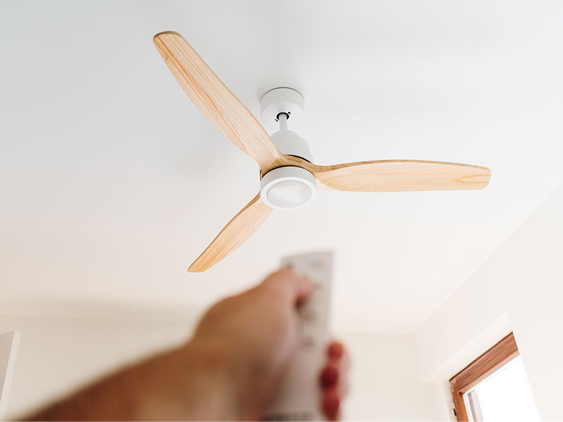 An electrician testing a ceiling fan