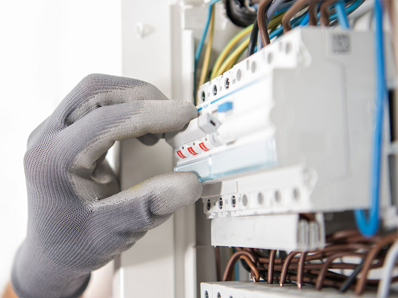 Byers Electric technician inspecting circuit breakers in a residential distribution panel