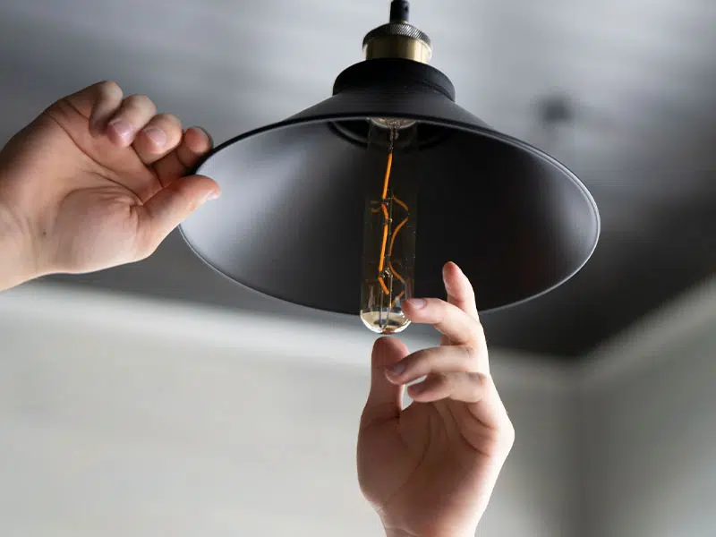 Byers Electric lighting upgrade—technician installing energy-efficient bulb