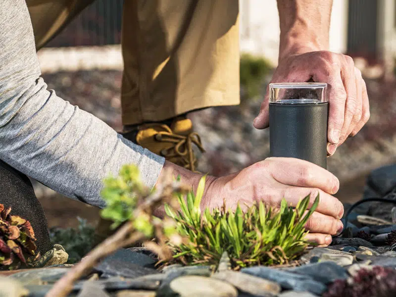 Byers Electric technician installing outdoor landscape lighting for enhanced curb appeal and safety