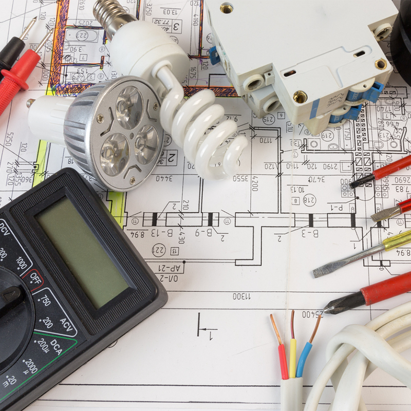 Byers Electric planning electrical installation with tools, wiring, and blueprint layout